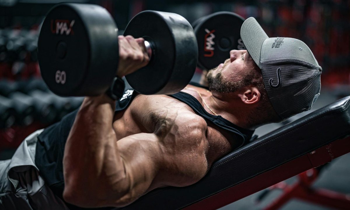 Athlete performing a heavy dumbbell press